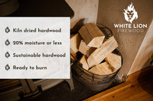 Load image into Gallery viewer, Basket of firewood next to a wood burning stove.
